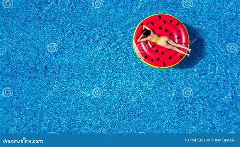 Aerial View Of Woman In Bikini Lying On A Floating Mattress In Swimming