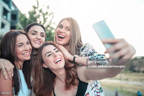 Group Of Girls Taking A Selfie Outdoors At City Park High Res Stock