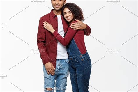 Full Body Portrait Of Young African American Hugging Couple With Smile