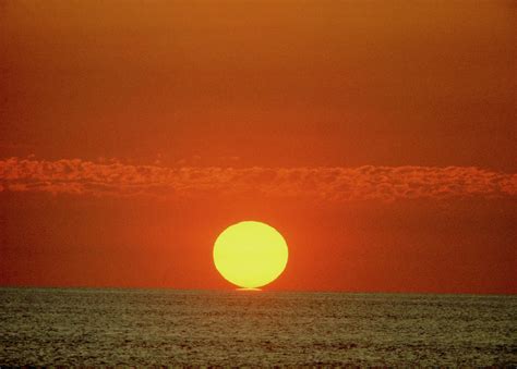 Sun Setting Over The Ocean Photograph By Ron Reidscience Photo Library