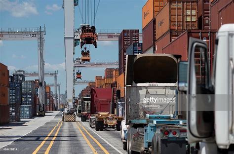 Trucks Wait To Be Loaded With Shipping Containers At The Port Of