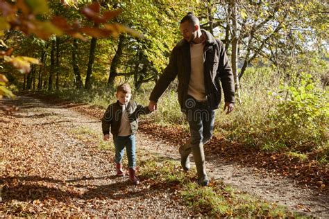 Father And Son On Autumn Walk In Woodland Together Stock Photo Image