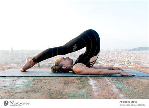 Flexible Woman Doing Plow Pose In City A Royalty Free Stock Photo