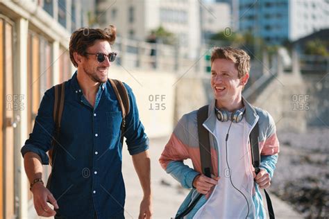 Best Friends Walking On Beach Smiling Hanging Out Two Guys Chatting Enjoying Summertime Stock