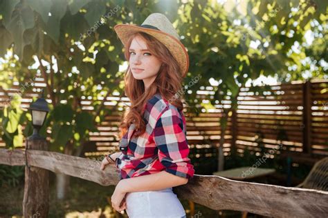Cute Smiling Redhead Cowgirl In Hat Leaning On Ranch Fence — Stock
