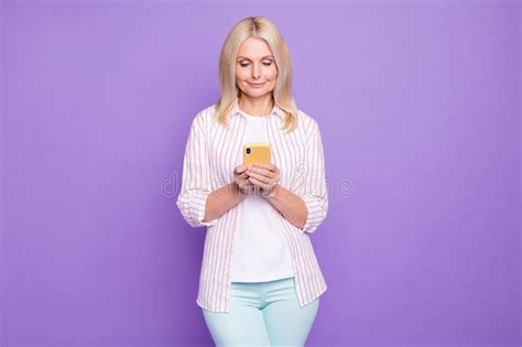 Photo Of Shiny Adorable Mature Woman Dressed Pink Shirt Typing Modern Device Isolated Purple