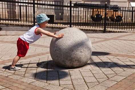 Child Pushing Great Heavy Ball — Stock Photo © Andyphotoland 12033078