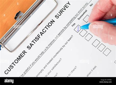 Hand Completing Customer Satisfaction Survey Stock Photo Alamy
