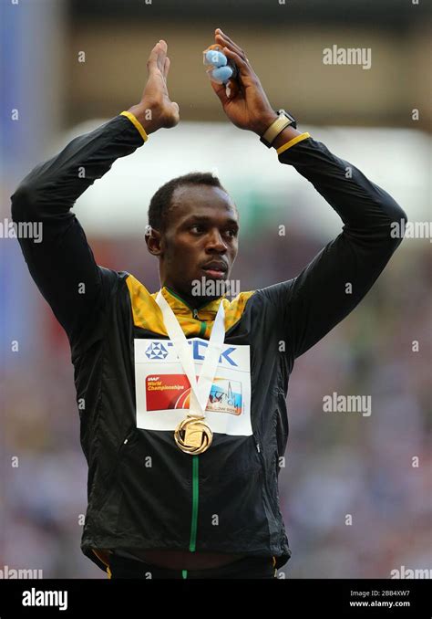 jamaica s usain bolt celebrates with his gold medal after winning the men s 200 metres stock