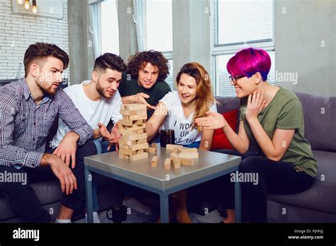 A Group Of Friends Play Board Games In The Room Stock Photo Alamy