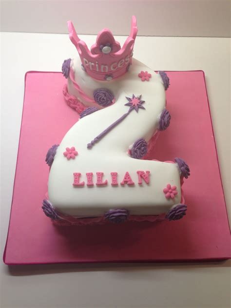 A Pink And White Birthday Cake With A Princess Crown On The Number Two