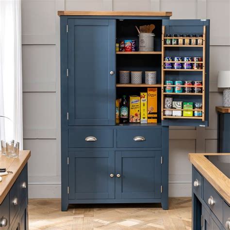 An Open Cabinet In The Middle Of A Kitchen