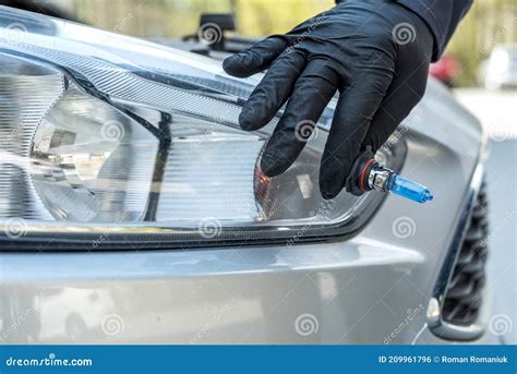 Mechanic Changing New Halogen Bulb In Car Headlight Stock Photo Image