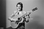 Singer and songwriter Paul Kennerley posed with acoustic guitar in ...
