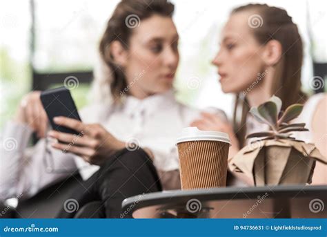 Coffee To Go On Tabletop With Lesbian Couple Behind Stock Image Image Of Homosexuality