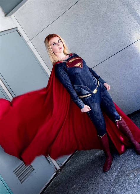 A Woman In A Superman Costume Poses For A Photo