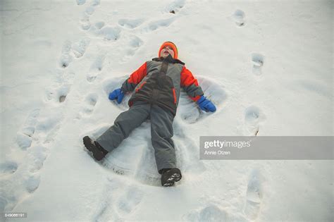 Little Boy Making Snow Angel High Res Stock Photo Getty Images