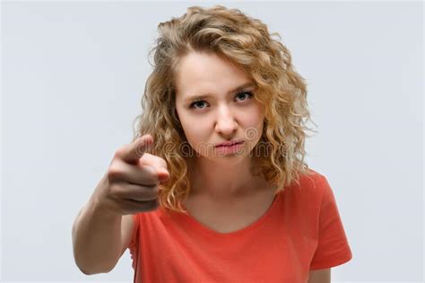 Pretty Young Woman With Curly Hair Looking At The Camera And Pointing Her Finger At You Human