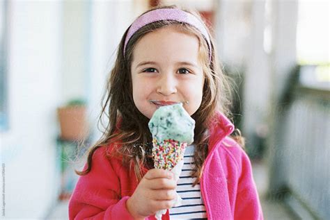 Cute Young Girl Eating A Big Ice Cream By Stocksy Contributor Jakob