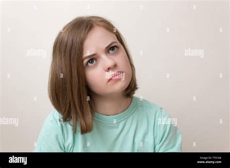 Portrait Of Young Caucasian Woman Girl With Questioning Puzzled