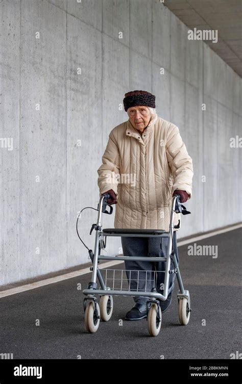 Senior Citizen With Walker Walks In An Underpass Hi Res Stock