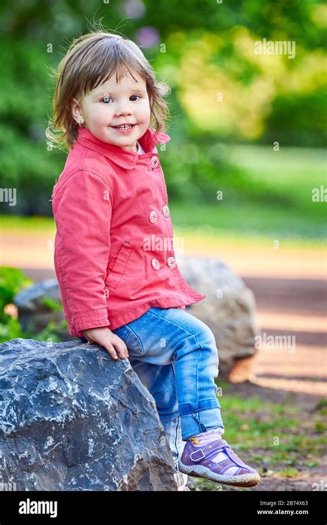 Happy Little Girl Smiling And Having Fun Stock Photo Alamy