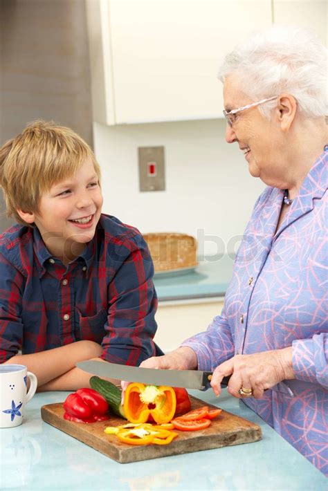 Grandmother And Grandson Preparing Food In Kitchen Stock Image Colourbox