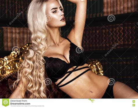 Beautiful Long Haired Blond Woman In Black Lingerie Posing