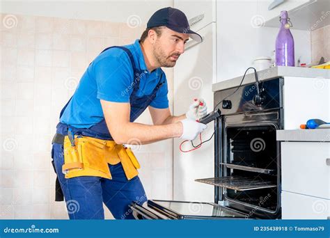 One Expert Repairman Fixing A Broken Kitchen Oven Stock Photo Image