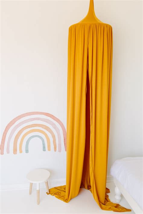 The perfect addition to any kids room or nursery, this canopy tent will make every room look magical and stylish. Hanging Tent Canopy - Mustard - Moocachoo