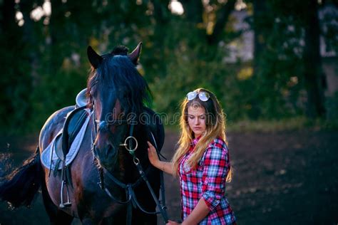 Beautiful Girl With Long Hair On A Walk With A Horse Stock Image