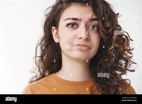 Headshot Disappointed Displeased Upset Curly Haired Cute Armenian Girl Frowning Dislike Cringing