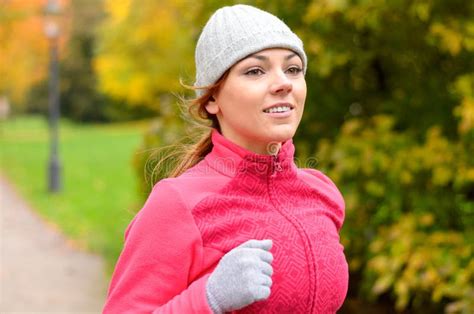 Smiling Fit Young Woman Jogging In A Park Stock Photo Image Of Park