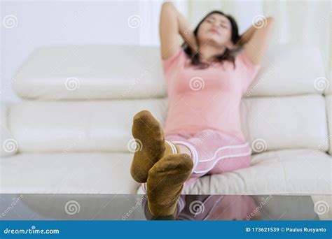 pretty sleeping woman on a couch feet with socks stock image image of hotel enjoy 173621539