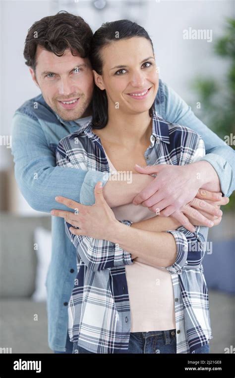 Couple Hugging In The Living Room Of Their New House Stock Photo Alamy