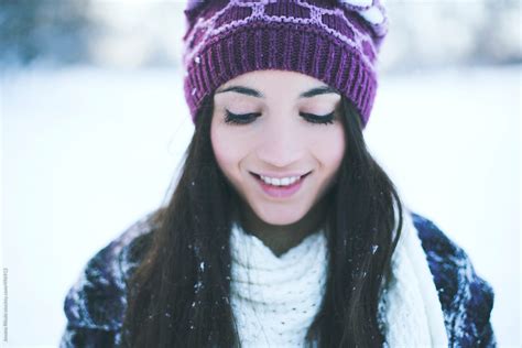 View Portrait Of A Smiling Young Woman On A Cold Snowy Day By Stocksy