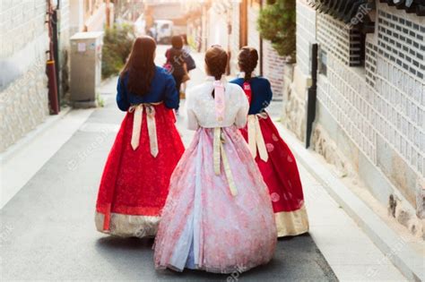 Back Of Two Women Wearing Hanbok Walking Through The