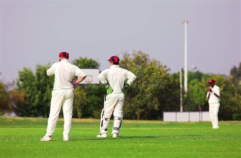 Cricket Players Standing Around Waiting On The Field Royalty Free Stock