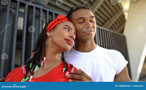 Mixed Race Couple Tenderly Hugging Dreaming About Bright And Happy