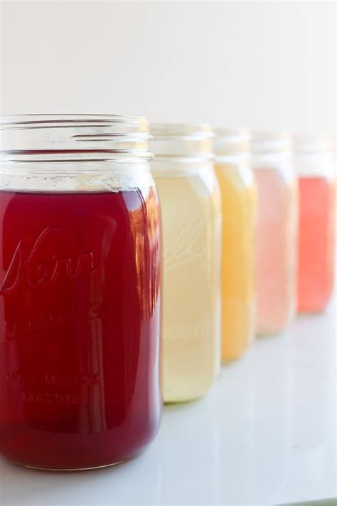 Several Jars Filled With Liquid Sitting On Top Of A White Counter Next
