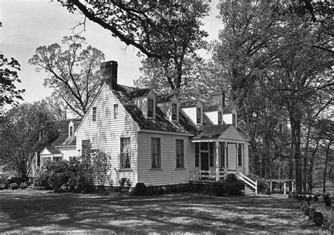 Black And White Photograph Of A House In The Woods