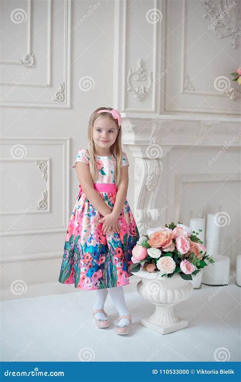 Full Length Of Little Smiling Girl Child In Colorful Dress Posing