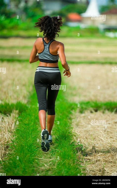 Back View Of Young Runner Woman With Attractive And Fit Body In Running
