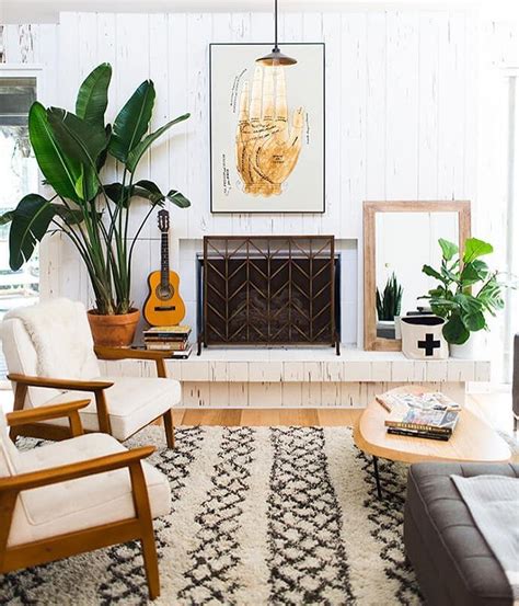 A living room is an essential heart of a house, which functions as an important place for socializing and relaxing. Cozy Moroccan rug, plants, mid century chairs. Love this ...