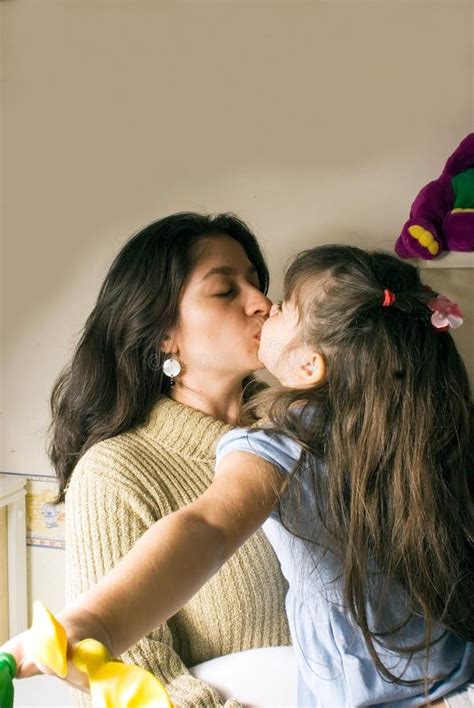 A Mother And A Daughter Kissing Picture Image