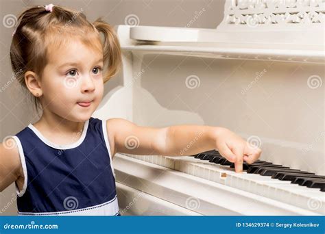 The Girl Is At The White Grand Piano Stock Photo Image Of Child