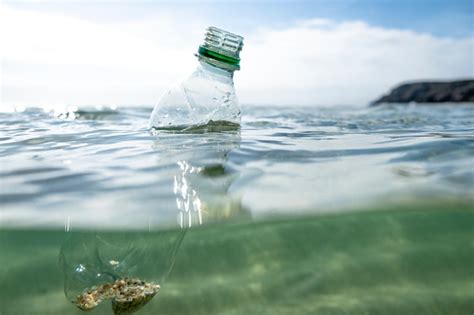 Used Plastic Water Bottle Floating On The Sea Surface Stock Photo