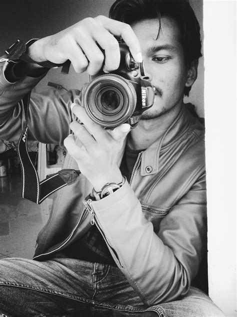 Free Photo Monochrome Photography Of Man Holding Black Nikon Camera