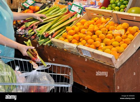Interior Of Retail Farm Shop Fruit Produce On Display Woman Shopper And