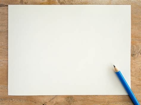 Premium Photo Blank White Paper With Pencil On Wood Table